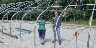 Brandy Phipps and Craig Schluttenhofer in aquaponics research structure