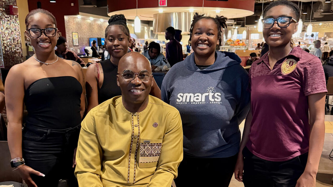 Dr. Kuti with students at a Sunday dinner