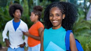 African American woman holding folder with <a href=