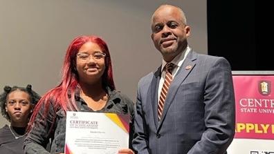 A scholarship recipient from Detroit stands with Central State University President Jack Thomas, Ph.D., on an Admissions recruiting tour.