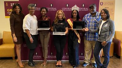 Central State University Vice President of Institutional Advancement Tiffiney Gray and Director of Strategic Partnerships and Corporate Engagement Kim Jones with students accepting laptops donated from the federal reserve banks of cleveland and cincinnati