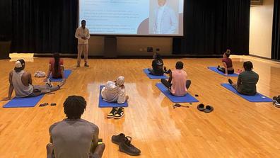 eight Black students sit on yoga mats during a mindfulness session sponsored by Central State University Counseling Services