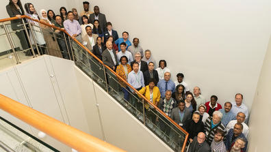 A large group of HBCU representatives standing on a stairwell looking up