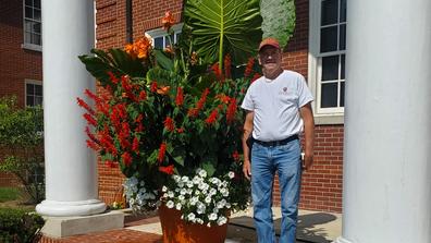 Brian Kampman, vegetable and small fruit crops technician for Central State University (CSU) Extension, stands by a floral display cultivated at CSU including Elephant Ears or Colocasia