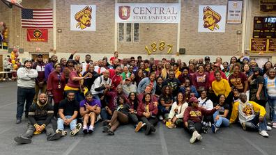 a group of alumni and students in the gymnasium at Central State University