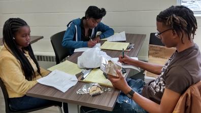 Students Mahogany Chapman, Raven Arnold, and Marcus Steel create an evidence log for their Crime Scene Analysis course at Central State University