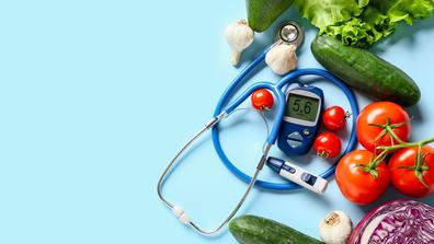 a stethoscope with fruits and tomatoes, cucumbers, garlic, and other vegetables on a blue background