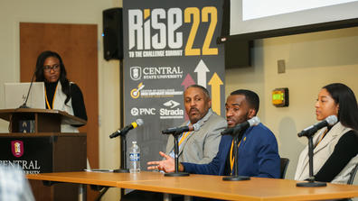 three panelists sit at a table at the 2022 RISE to the Challenge Summit at Central State University with the moderator looking on