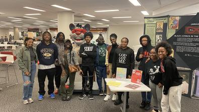 eleven central state university students stand in a group in front of a comics display at the national afro-american museum and cultural center in wilberforce ohio