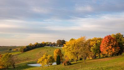 Colorful autumn trees and a pond on a hillside in Amish country, Ohio