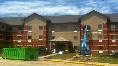 construction crews work under a bright blue sky outside foundation hall 1 at central state university