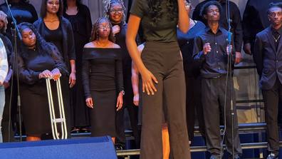 a student singing a solo during a central state university choral concert