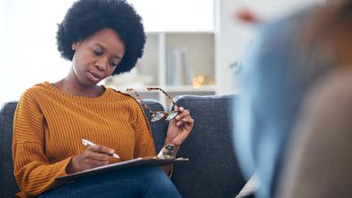 an african american community health worker in a home