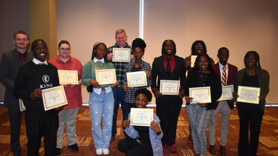 a group of students holding certificates