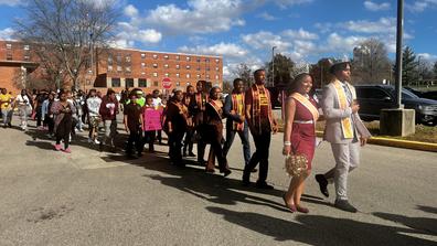 central state university students led by the royal court march to the polls on election day