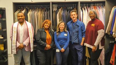 five people stand in front of a wardrobe filled with professional attire in the new Marauder Boutique A Treasure Chest for Success at central state university