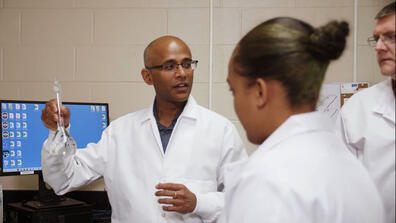 Dr. Sakthi Kumaran in a lab with students