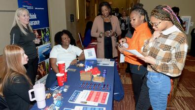 group of central state university students around a table on insurance day 2024