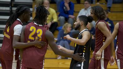 marauder men's volleyball team huddles during game against mount Saint Joseph University