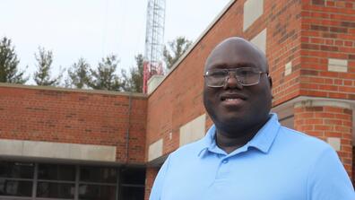 dr. colin lasu outside the central state university mass communications center