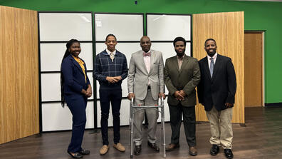 five people including students, president kuti and stanley jefferson pose for a photo in the television studio at central state university