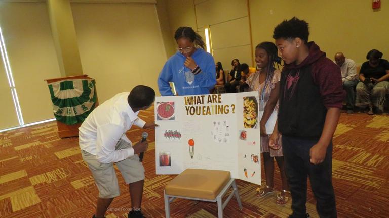 participants in the Central State University Extension youth summer camps look over a presentation about nutrition