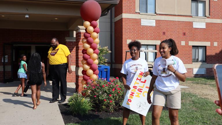 students outside a residence hall