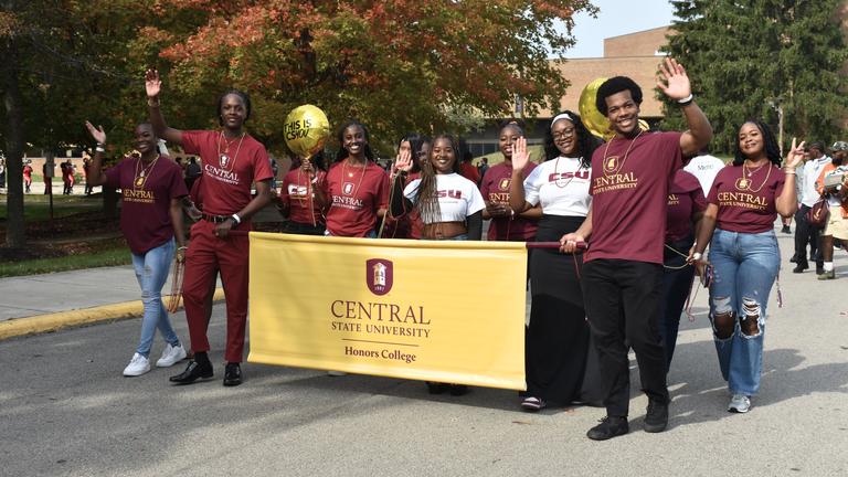 central state university honors college members march in the 2024 homecoming parade