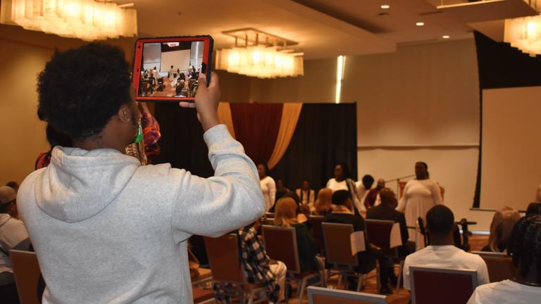 a young person captures a performance by praise in motion