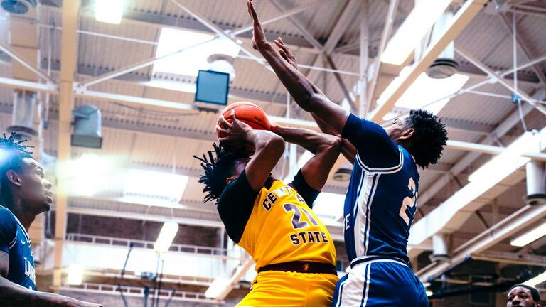 marauder men's basketball player taking a shot over a lane college dragon