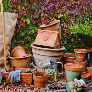 gardening supplies such as a shovel planters pots gloves