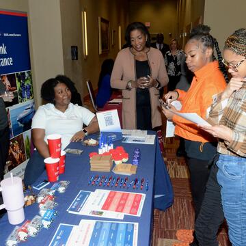 group of central state university students around a table on insurance day 2024