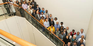 A large group of HBCU representatives standing on a stairwell looking up