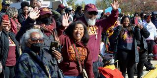 a large crowd of Central State University Centralians alumni and supporters waves in excitement