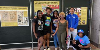 Central State University students pose beside a display of The Golden Age of Black comics at the National Afro-American Museum & Cultural Center on the campus of Central State in Wilberforce, Ohio