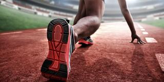 closeup of a runner preparing to race in a stadium