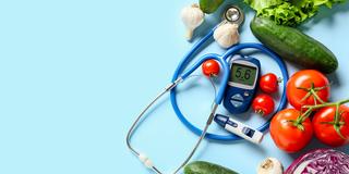 a stethoscope with fruits and tomatoes, cucumbers, garlic, and other vegetables on a blue background