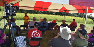 a speaker from Central State University Land-Grant Extension presenting information under a red and white tent at the 61st annual Farm Science Review in London, Ohio