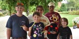 youth participating in the Homeschool Adventures program by Central State University Extension pose with some of the plants they helped grow with Extension Associate Clare Thorn at the Seed to Bloom Botanical and Community Garden