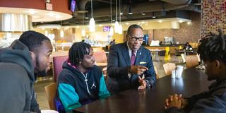 central state university interim president talks with students in the university student center