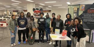 eleven central state university students stand in a group in front of a comics display at the national afro-american museum and cultural center in wilberforce ohio