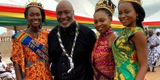 John Dunn and four young women in African cultural attire at a leadership trip with the NAACP in Accra Ghana
