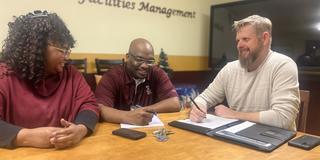 three people gather in a facilities management conference room at central state university