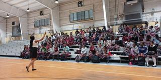 Ashley Clarke of Central State University pumps up a crowd of high school students on a recruiting trip