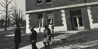1974 tornado survivors stand outside a mostly intact building on the central state university campus but whose windows have been destroyed