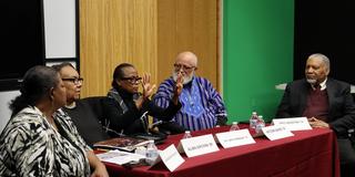 five panelists including alumni faculty and staff sit around a table discussing the 1974 tornado at central state university