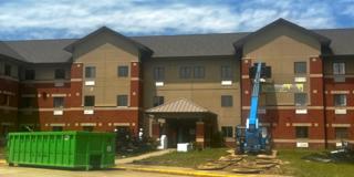 construction crews work under a bright blue sky outside foundation hall 1 at central state university