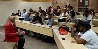 dayton mayor and central state university graduate jeffrey mims sits on a stage while speaking to students in a lecture hall