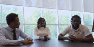 three students sitting around a table