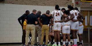 central state university men's basketball team huddles with coaches